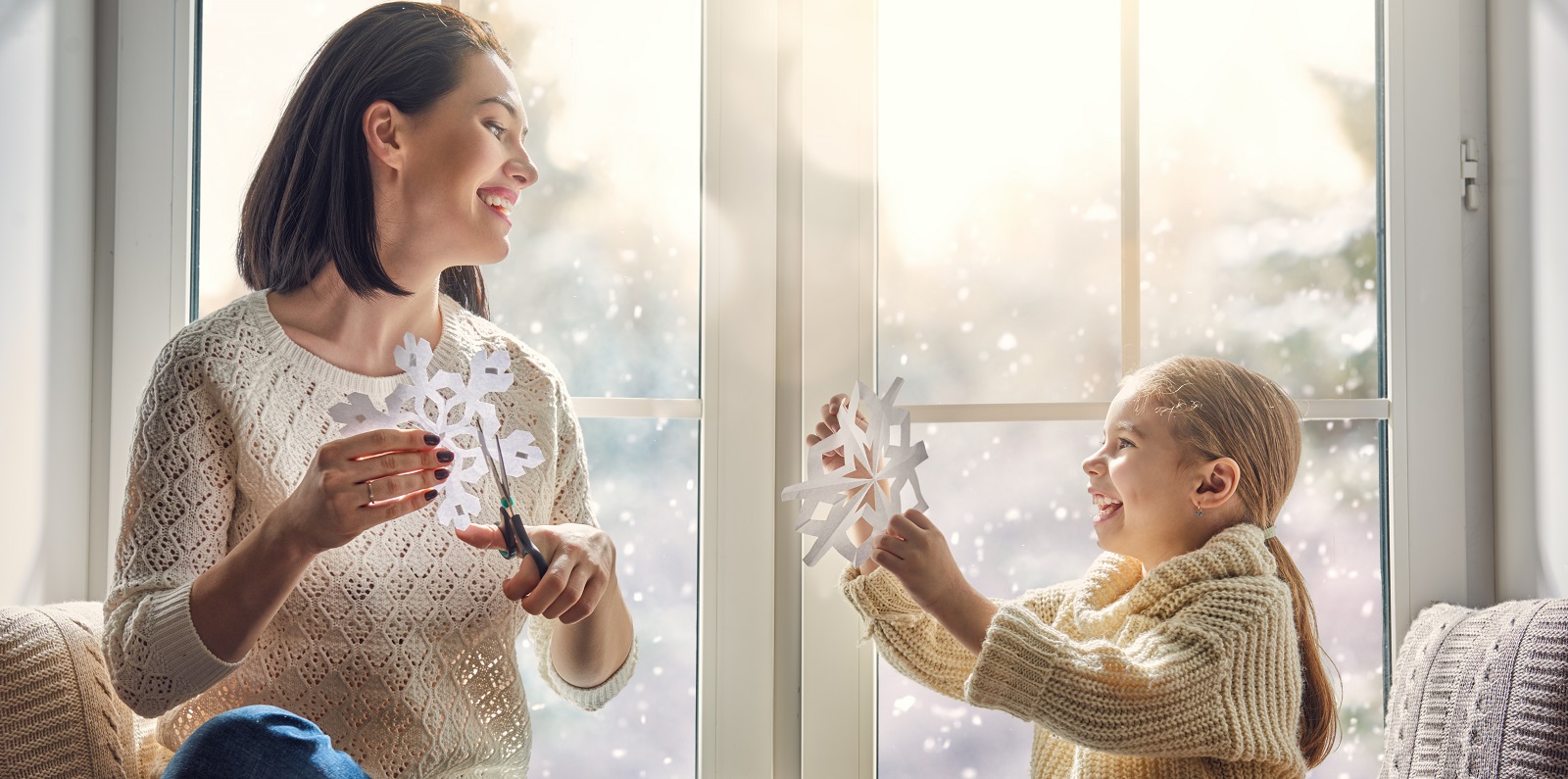 Mother and daughter with snowflakes