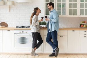 Couple drinking wine in kitchen