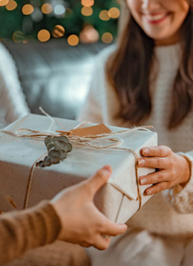 Woman giving a gift to someone