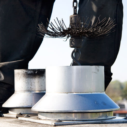 Person sweeping chimney