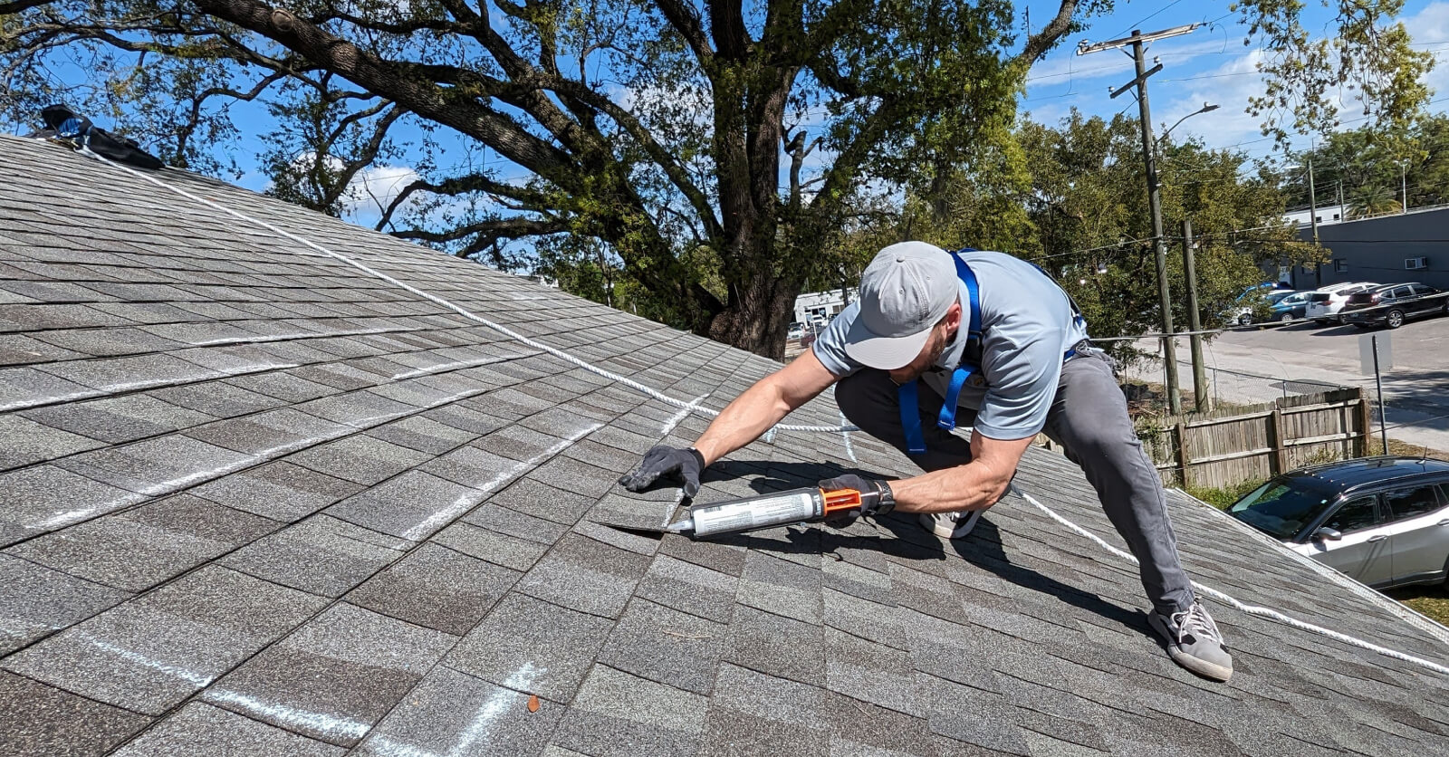 Man resealing roof shingles